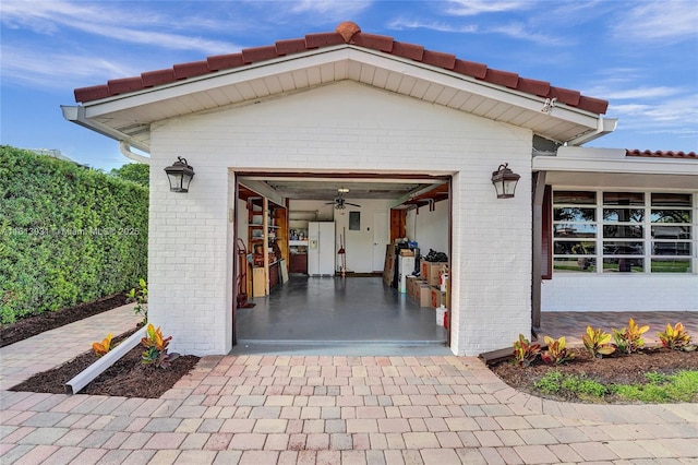 garage featuring white fridge with ice dispenser