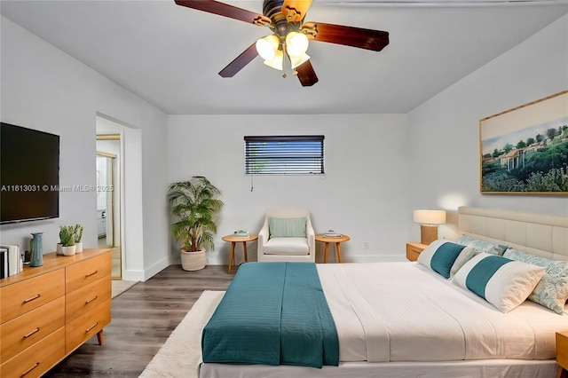 bedroom with dark wood finished floors, baseboards, and ceiling fan