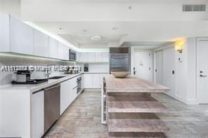 kitchen with white cabinetry and appliances with stainless steel finishes