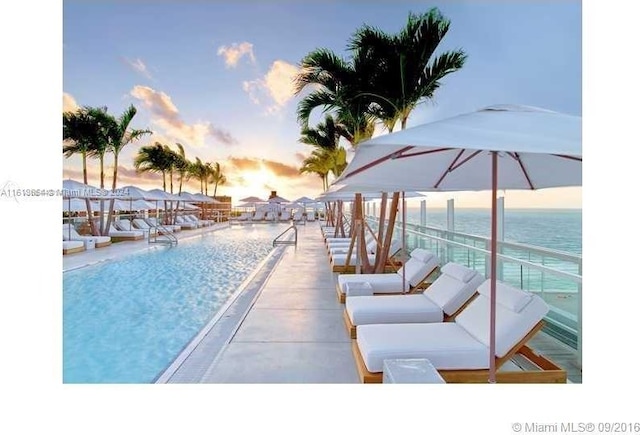 pool at dusk with a water view