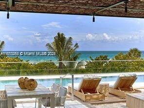 view of pool with a patio and a water view