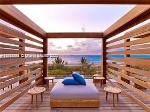 deck at dusk featuring a water view and an outdoor hangout area