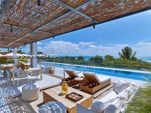 view of pool with a water view and a pergola