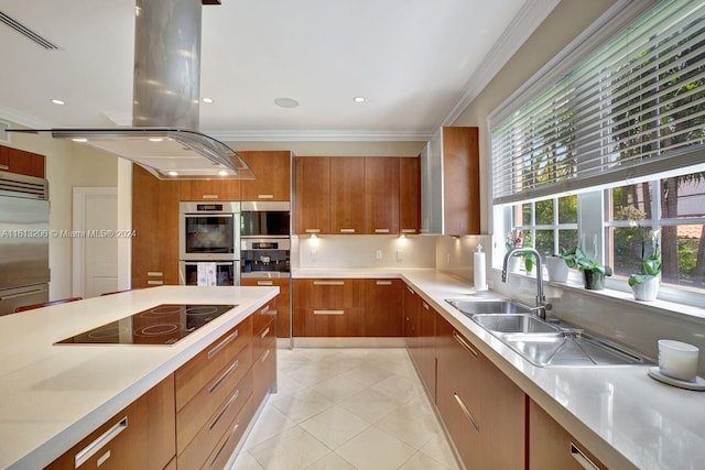 kitchen featuring appliances with stainless steel finishes, sink, island exhaust hood, crown molding, and light tile patterned floors