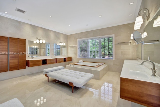 bathroom with crown molding, vanity, a relaxing tiled tub, and tile walls