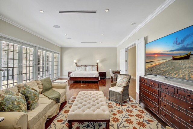 bedroom featuring built in desk, crown molding, a chandelier, and dark hardwood / wood-style floors