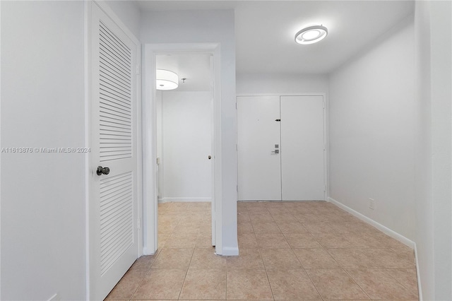 hallway featuring light tile flooring