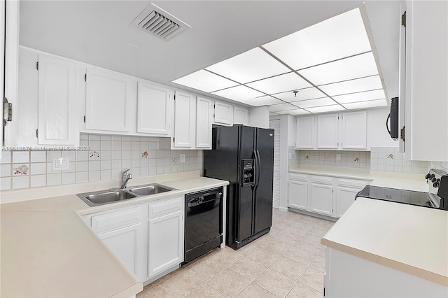 kitchen featuring white cabinets, light tile flooring, backsplash, black appliances, and sink