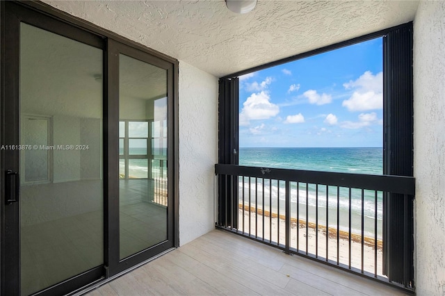 balcony with a beach view and a water view