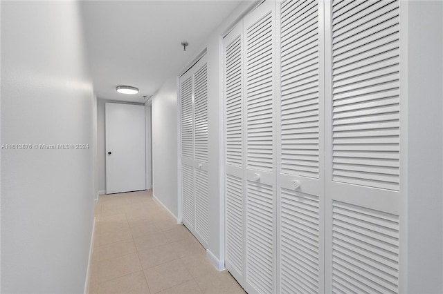 hall featuring light tile floors