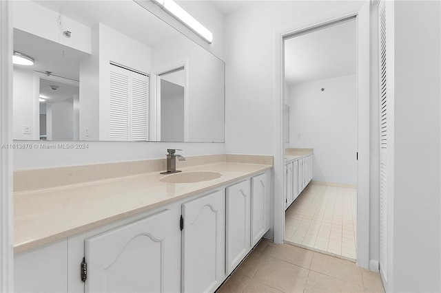 bathroom featuring tile flooring and vanity