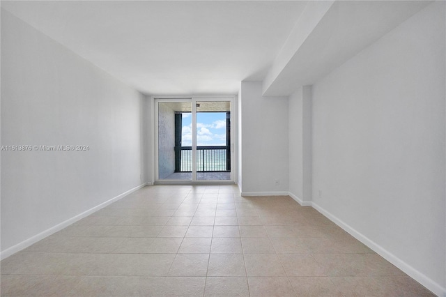 tiled empty room with expansive windows