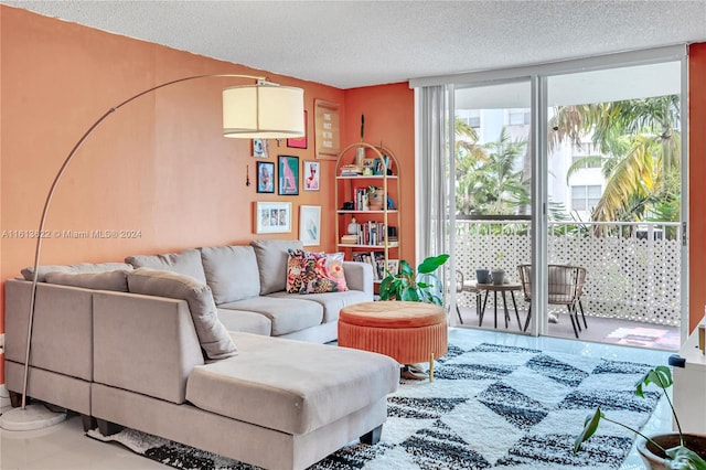 living room with a textured ceiling, tile patterned floors, and floor to ceiling windows