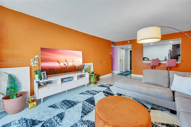 living room featuring a textured ceiling