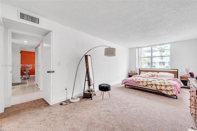 carpeted bedroom featuring a textured ceiling