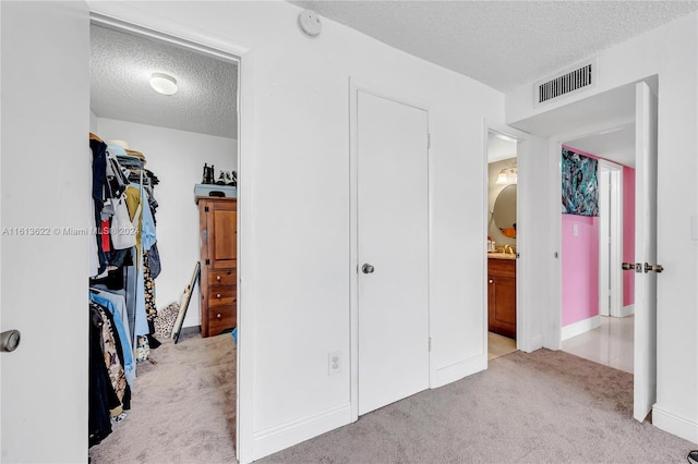 carpeted bedroom with a textured ceiling