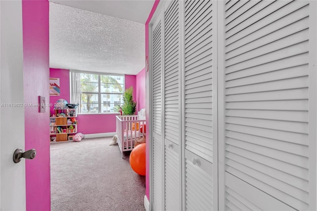 carpeted bedroom featuring a textured ceiling