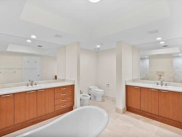 bathroom featuring a tub to relax in, tile patterned floors, vanity, a bidet, and toilet