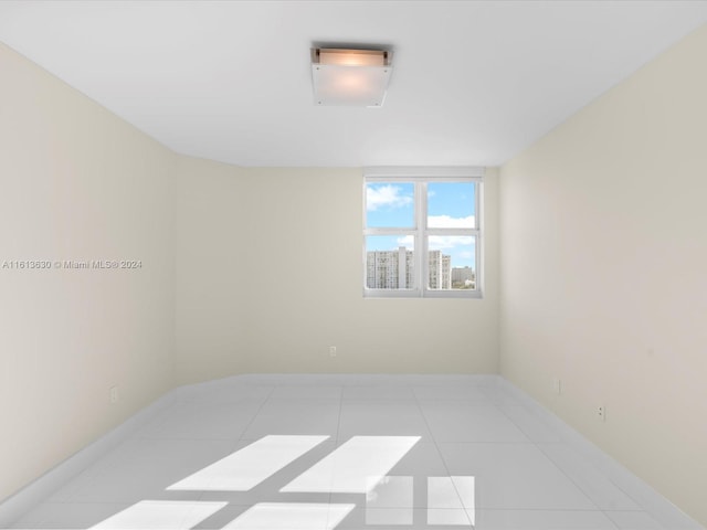 unfurnished room with light tile patterned floors