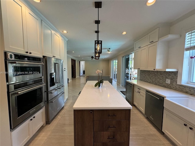 kitchen with decorative backsplash, stainless steel appliances, light tile patterned floors, and plenty of natural light