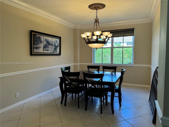 tiled dining space featuring a notable chandelier and ornamental molding