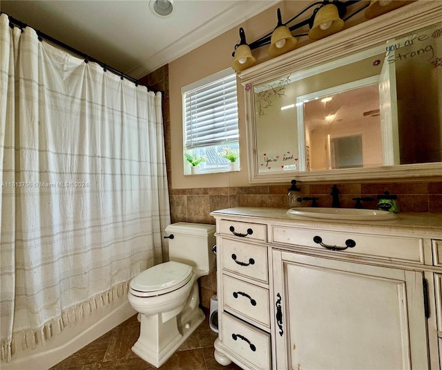 bathroom featuring crown molding, toilet, vanity, tile walls, and tile patterned floors