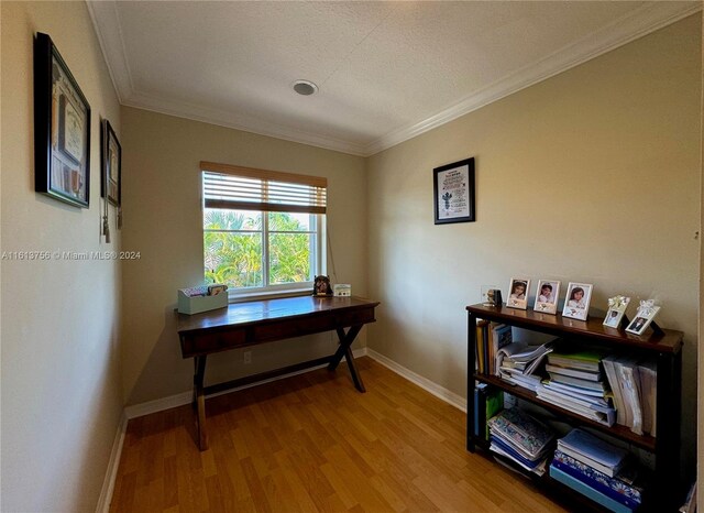 misc room featuring crown molding, hardwood / wood-style floors, and a textured ceiling