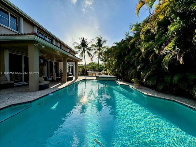 view of pool with a patio area and ceiling fan