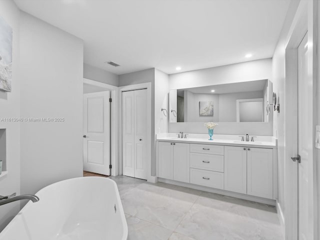 bathroom with vanity and a tub