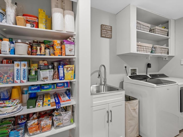 clothes washing area with sink and washer and dryer