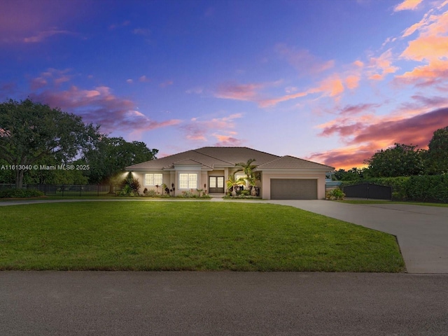 view of front facade featuring a yard and a garage