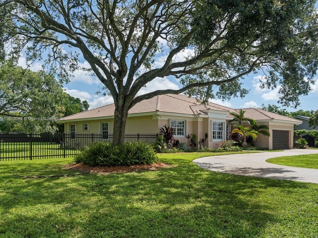 single story home featuring a garage and a front yard