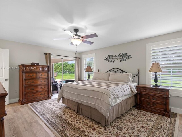 bedroom featuring ceiling fan, light hardwood / wood-style floors, and access to outside