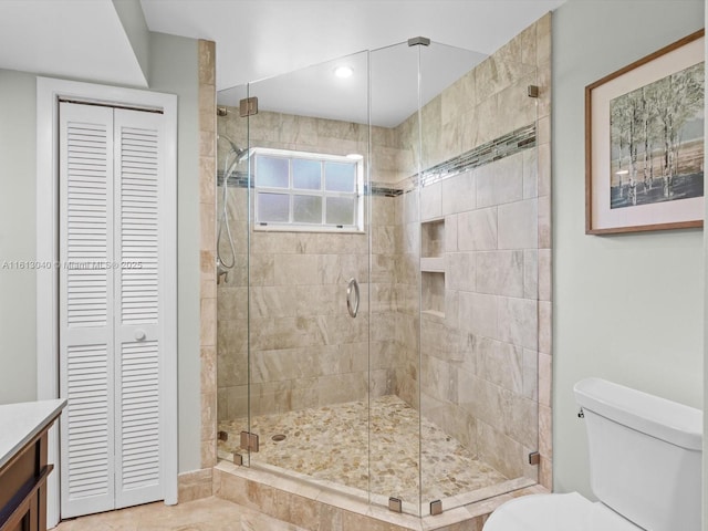 bathroom featuring walk in shower, vanity, and toilet