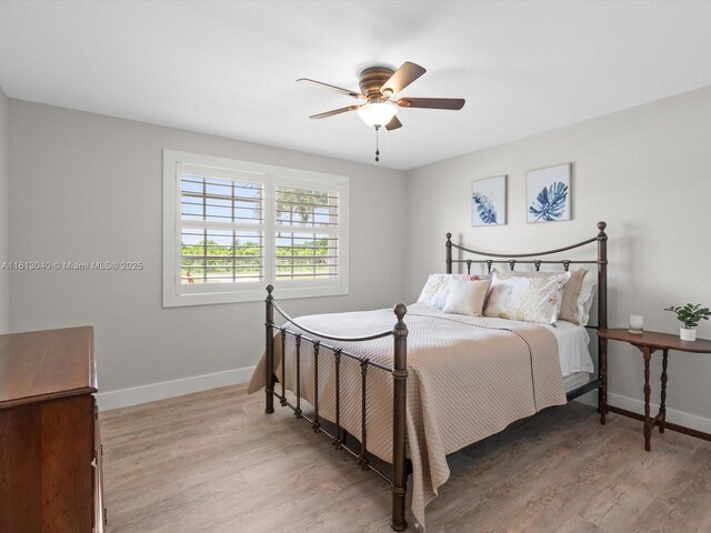 bedroom with ceiling fan and hardwood / wood-style floors