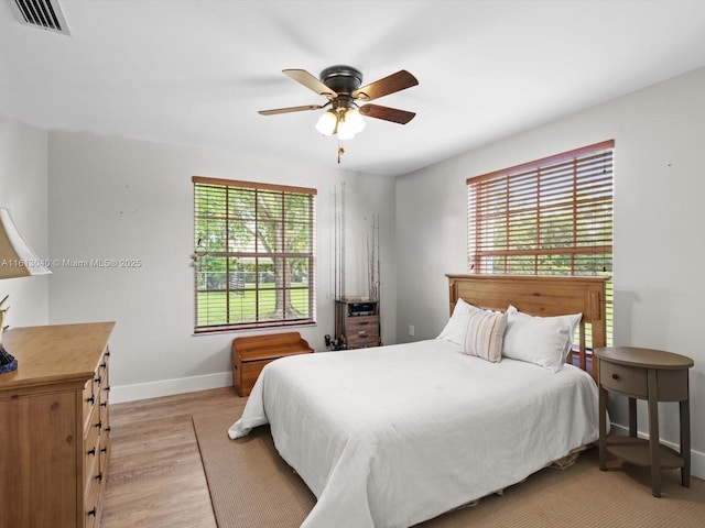 bedroom featuring light hardwood / wood-style floors and ceiling fan