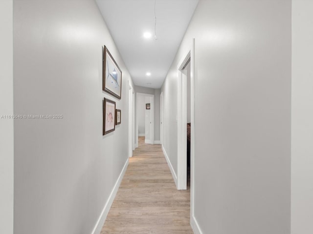 hallway with light hardwood / wood-style floors