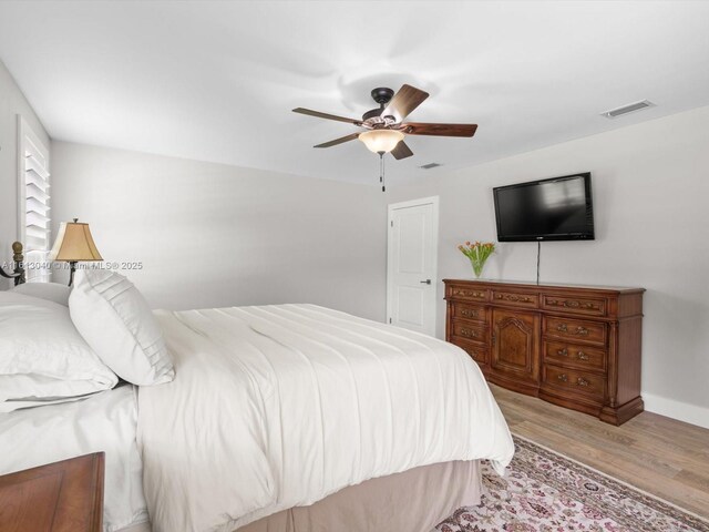 bedroom with ceiling fan and light hardwood / wood-style flooring