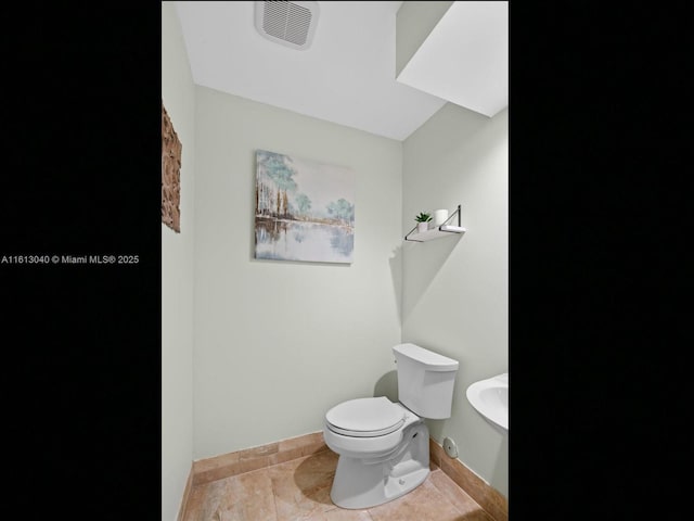 bathroom featuring tile patterned floors and toilet