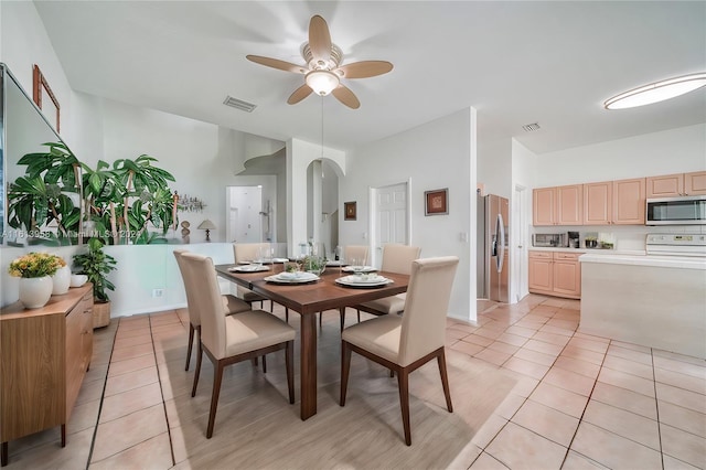 tiled dining area featuring ceiling fan