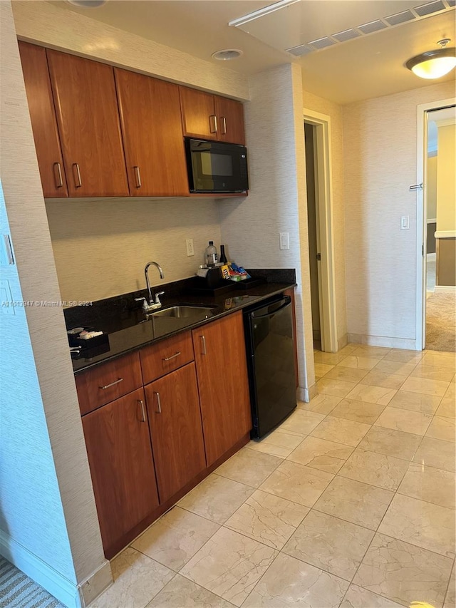 kitchen with sink, light tile patterned floors, and black appliances