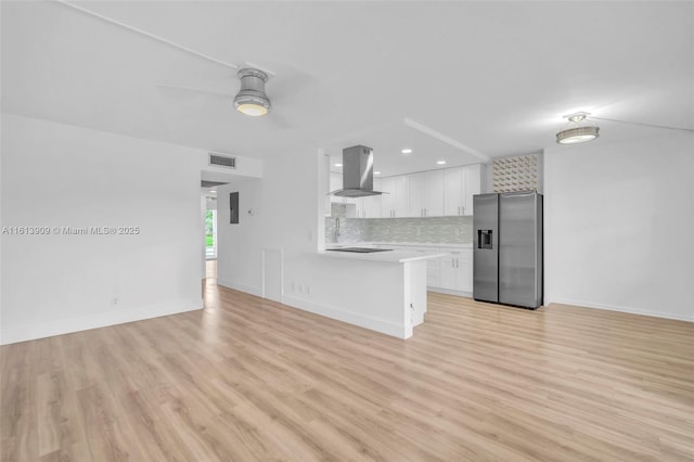 unfurnished living room featuring ceiling fan and light wood-type flooring