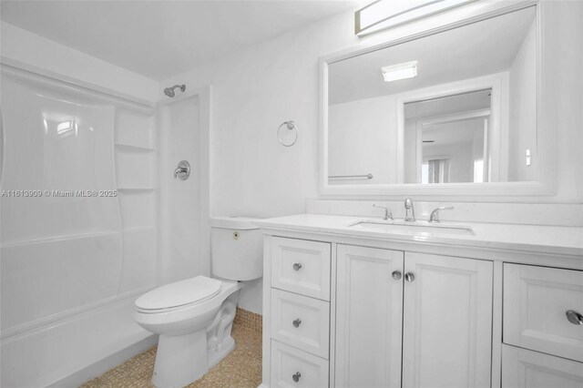 bathroom featuring walk in shower, vanity, and toilet