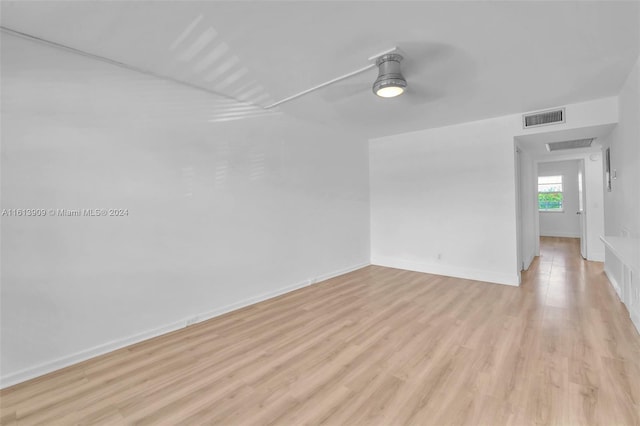 empty room with light wood-type flooring and ceiling fan