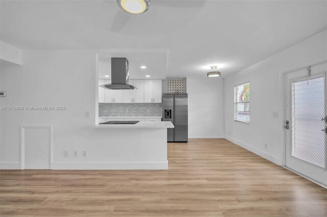 unfurnished room with ceiling fan and light wood-type flooring