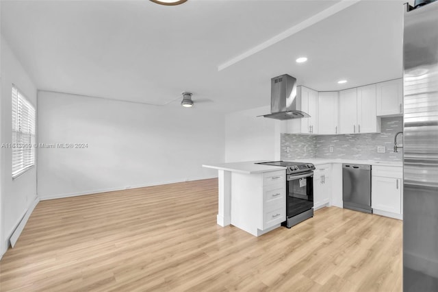 kitchen with appliances with stainless steel finishes, extractor fan, white cabinetry, decorative backsplash, and light wood-type flooring