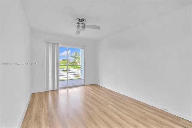 empty room featuring ceiling fan and light hardwood / wood-style floors