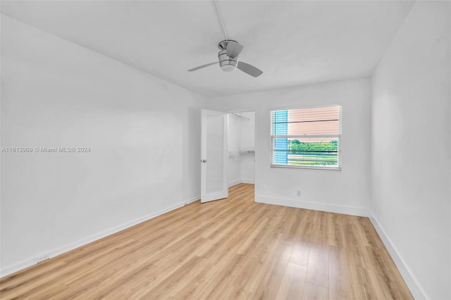 unfurnished room with light wood-type flooring and ceiling fan