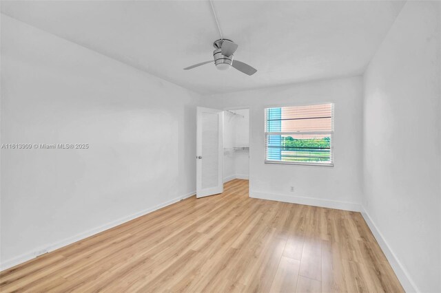 empty room with light hardwood / wood-style floors and ceiling fan