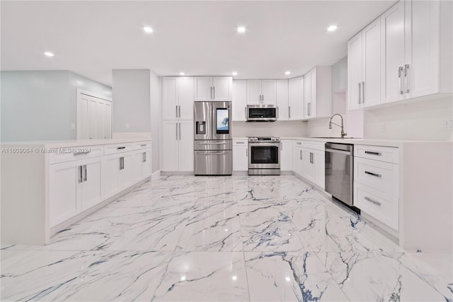 kitchen featuring appliances with stainless steel finishes, sink, and white cabinets